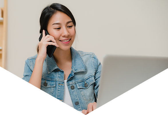 Woman talking on phone and using laptop