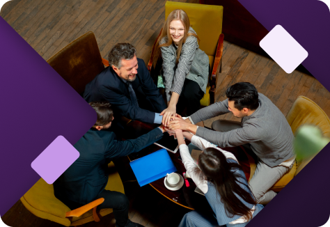 Group of people on laptops sat around desk